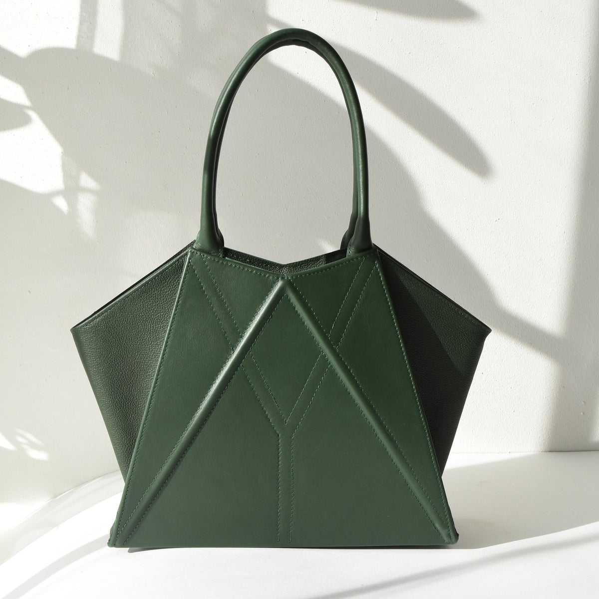 7. Studio shot of Gerda Retter Design Leather Handbag Nova in green, featuring its elegant geometric design