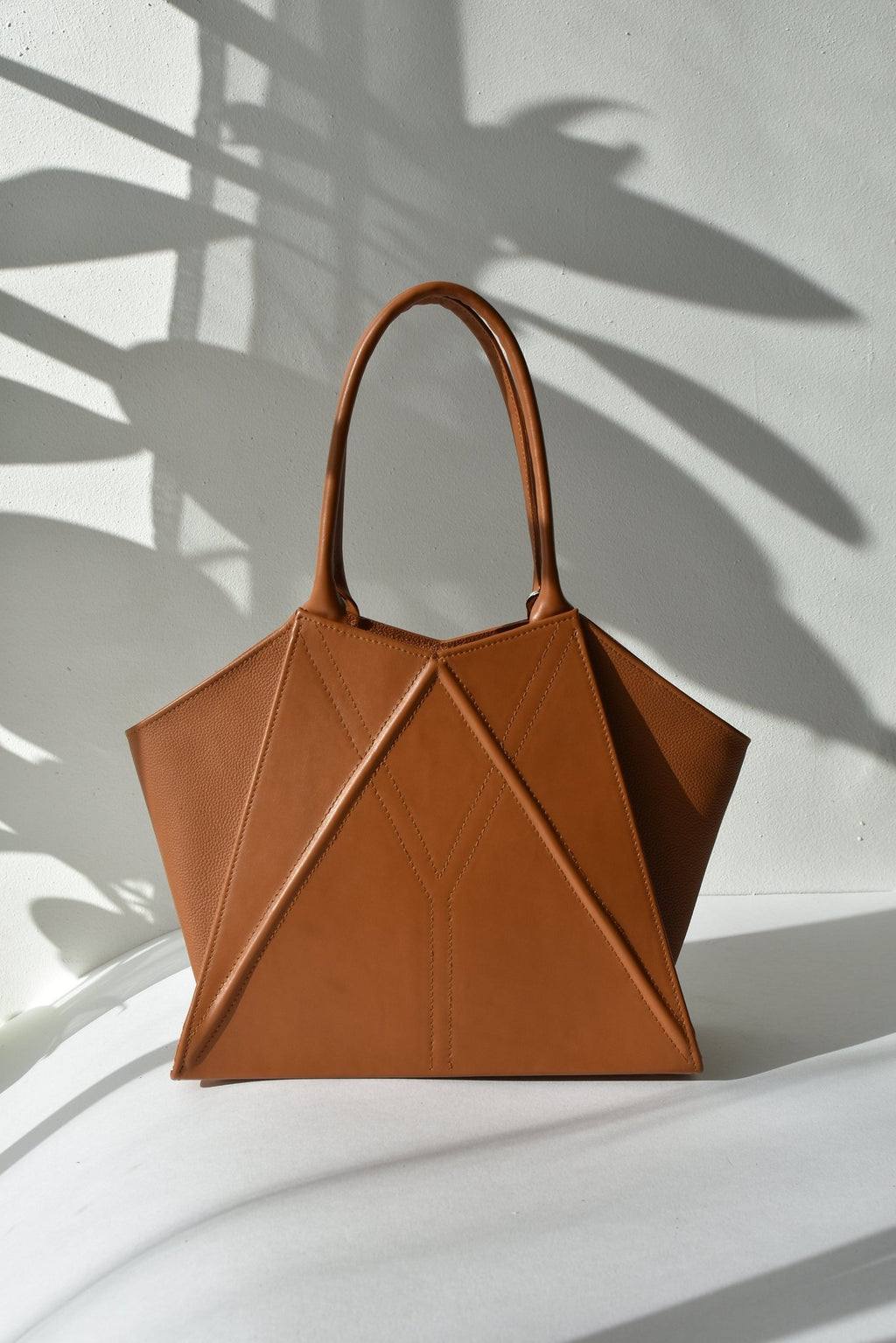 6. Studio shot of Gerda Retter Design Leather Handbag Nova in caramel brown, highlighting its unique shape