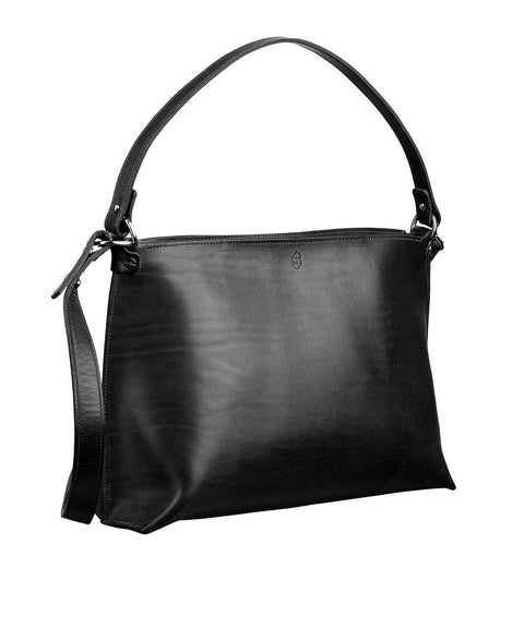 3. Black leather handbag by Stella Soomlais in studio setting, showing front view with adjustable strap and minimal design.