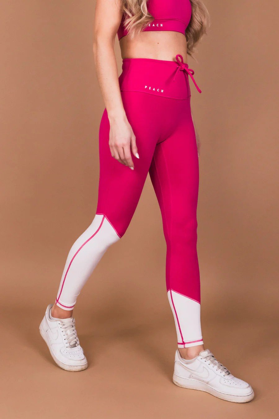 1. Women's Raspberry Dream leggings by Peachlabel in studio, featuring high-waisted design and V-shaped contour seam