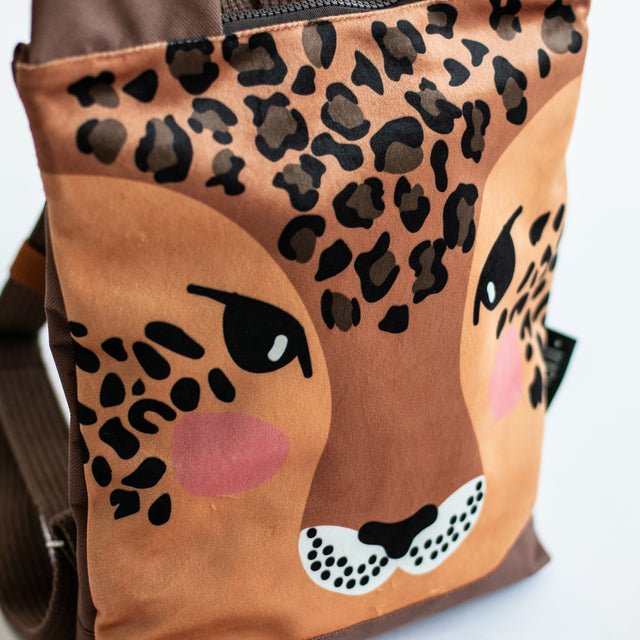 8. Close-up of Muni leopard backpack, highlighting detailed face design and velvet fabric