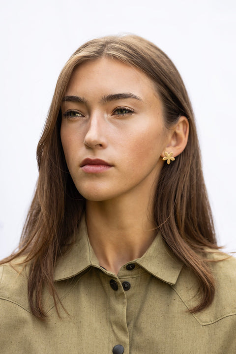 1. Woman wearing Lentsius Sunlit gold-tone flower earrings, facing forward with neutral expression