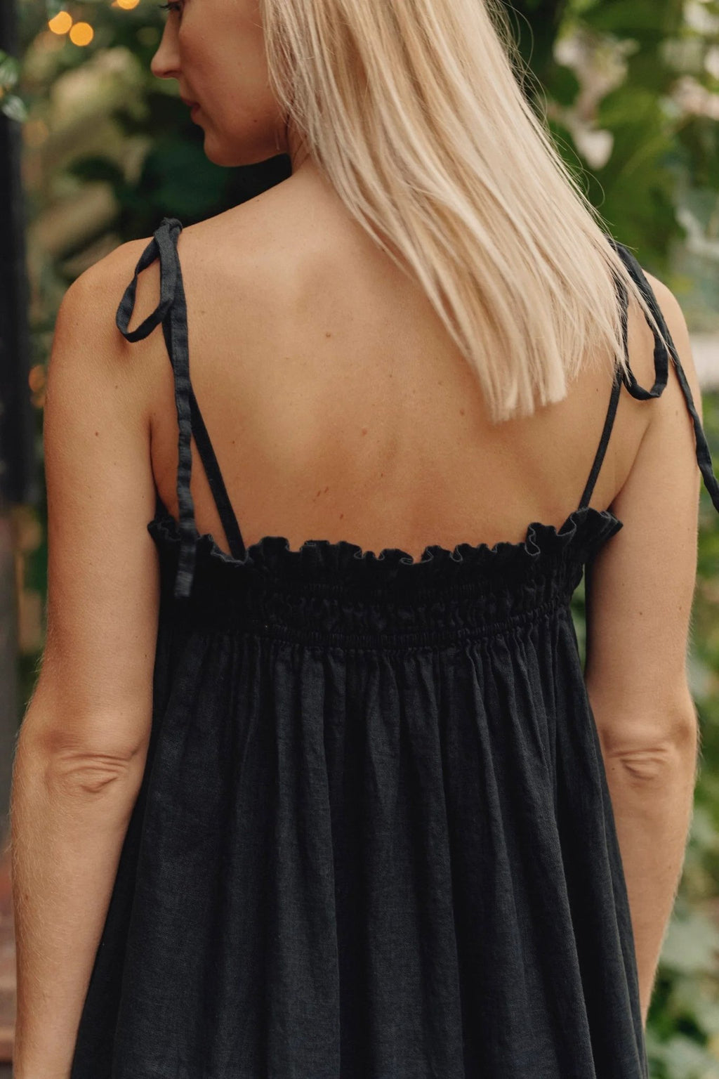 3. Close-up of back view of black linen Ballade dress showing tie spaghetti straps and elasticated top