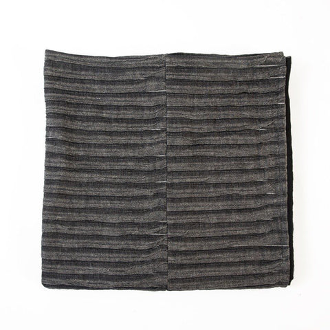 5. Flat lay of black and gray linen-cotton bedcover showing corrugated weave and folded design