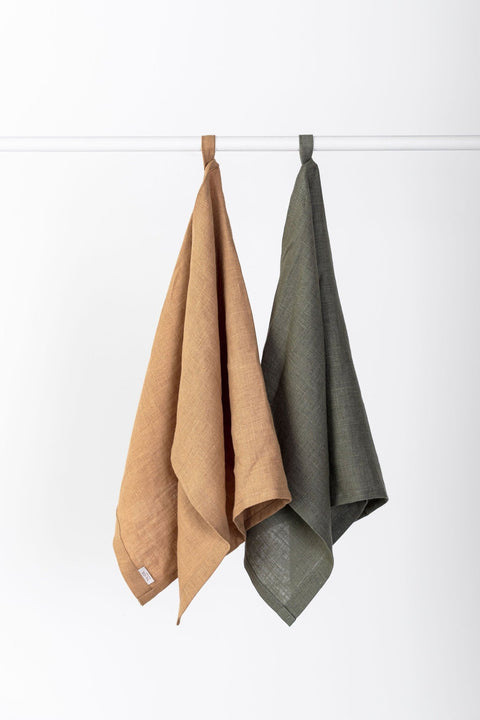 4. Two linen kitchen towels in caramel and olive hanging on a rod