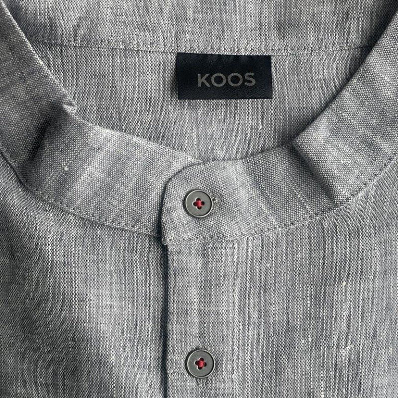 4. Close-up of blue-gray linen dress collar with KOOS label and metal buttons
