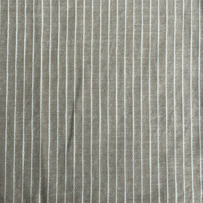 2. Close-up of linen sauna seat cover fabric with vertical light stripes, highlighting texture and mixed fibers.