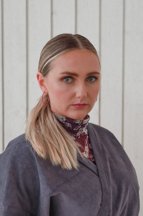 2. Woman wearing Lisa Kroeber Jewellery Lines Earrings, front view