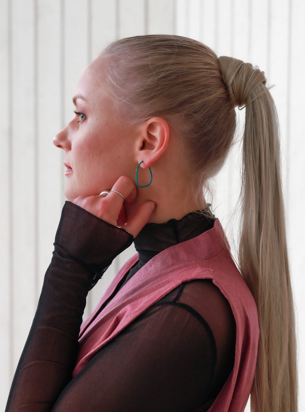 1. Woman wearing Lisa Kroeber Jewellery Lines Earrings, side profile view