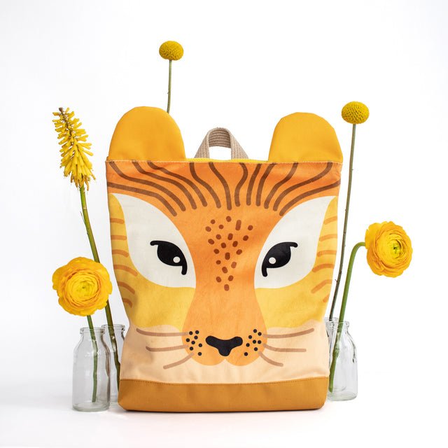 8. Muni lion backpack with yellow flowers in studio setting