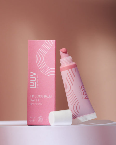 1. LUUV Lip Gloss Balm in Sweet with packaging, showcasing soft pink shade and eco-friendly certification