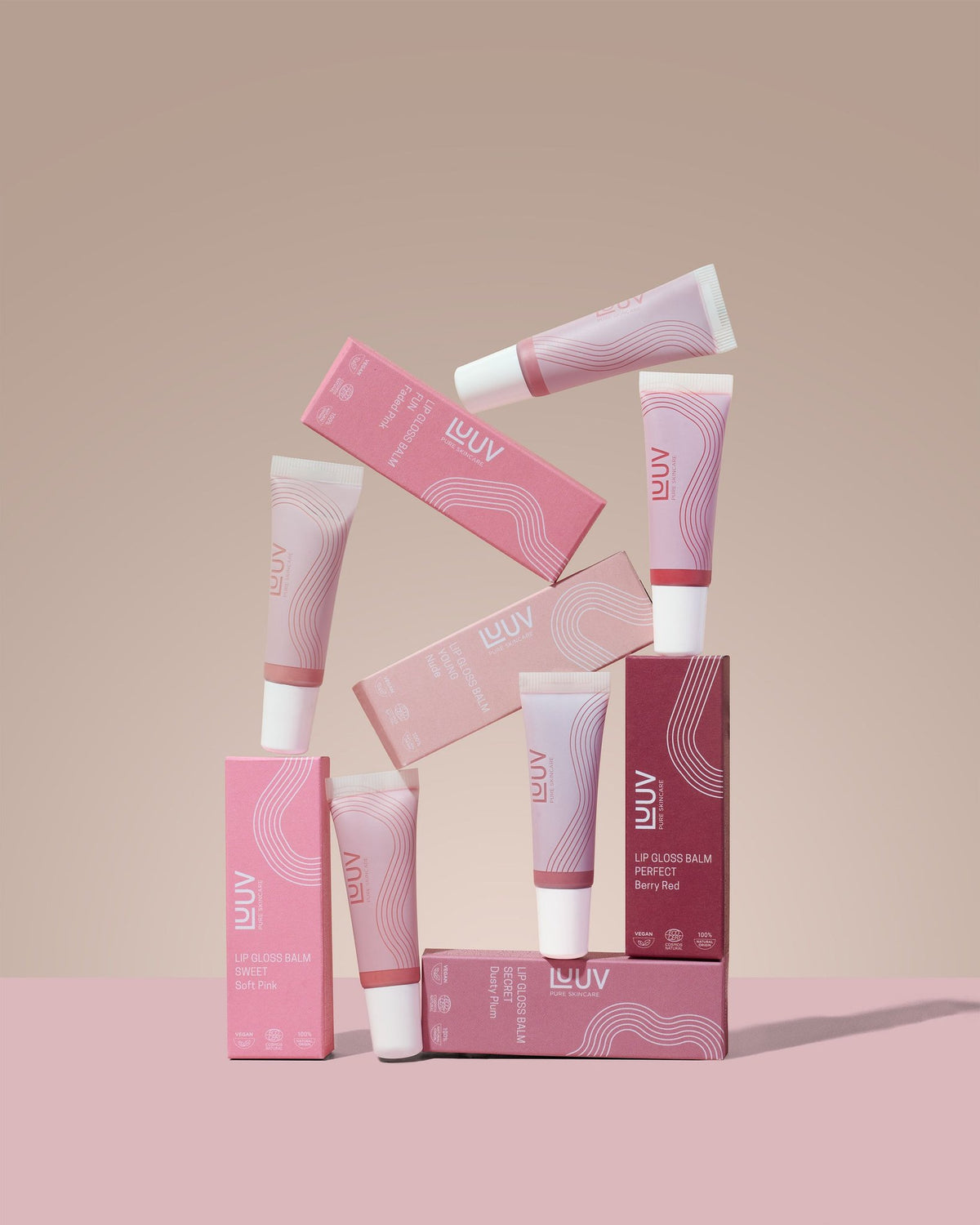 3. LUUV Lip Gloss Balm tubes and boxes in Sweet and Berry Red shades, arranged creatively