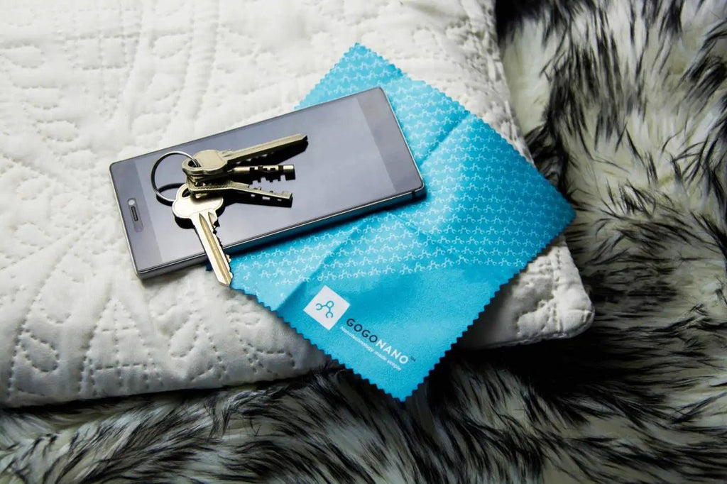 3. Smartphone with keys on screen, resting on GoGoNano branded cloth, showcasing scratch protection