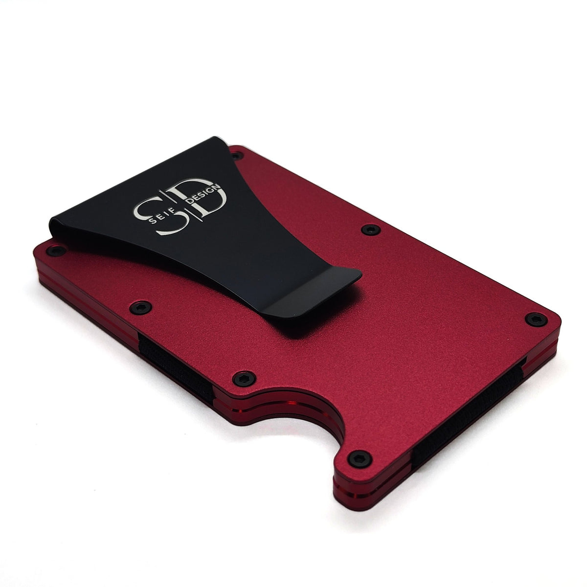 2. Angled view of red aluminum card holder by Seif Design with black clip, showing logo, on white background