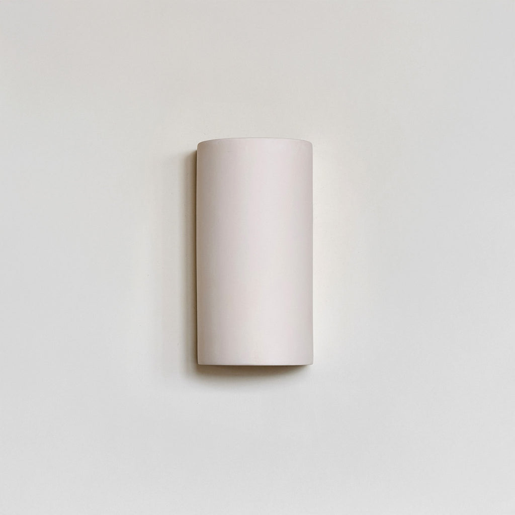 2. Studio shot of ceramic wall light in extra matte white on neutral wall