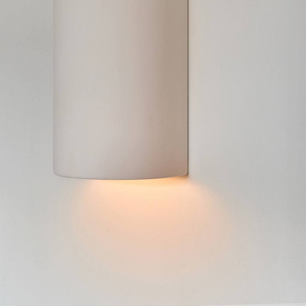 3. Close-up of ceramic wall light in extra matte white with warm light