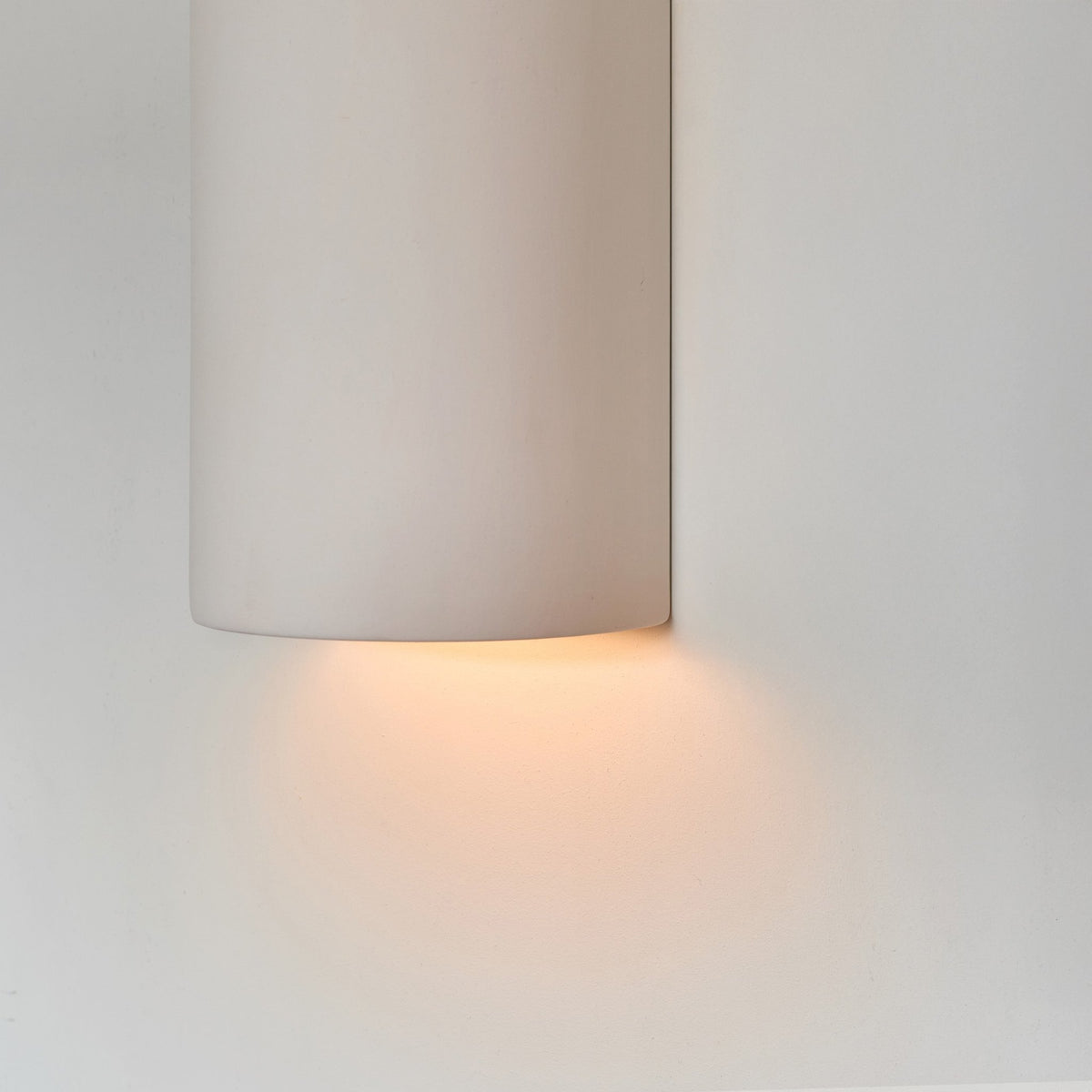 3. Close-up of ceramic wall light in extra matte white with warm light