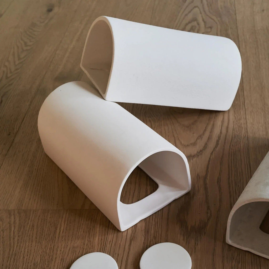 4. Flat lay of ceramic wall light components on wooden floor