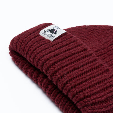 3. Close-up of burgundy chunky beanie showing Moomin NordicBuddies logo on ribbed fabric