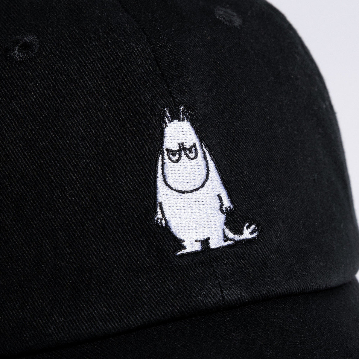 5. Close-up of embroidered Grumpy Moomintroll design on black cotton Dad Cap