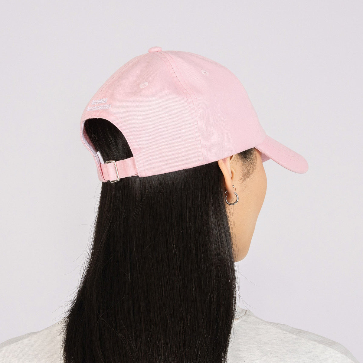 5. Woman wearing pink Moomin Dad Cap, back view in studio