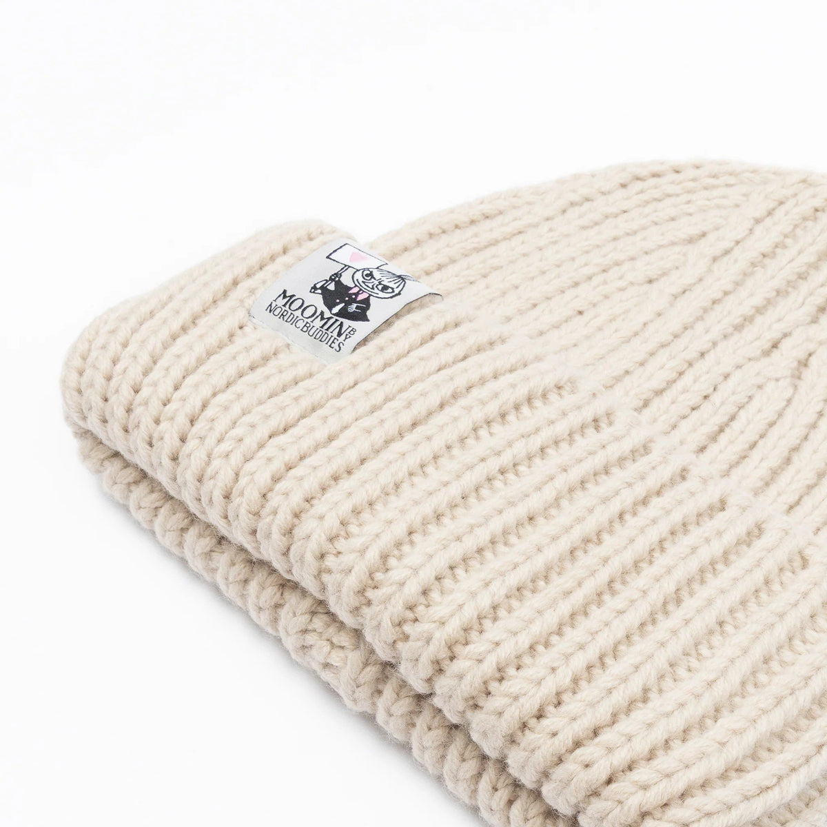 3. Close-up of folded beige ribbed beanie with Moomin logo highlighting texture