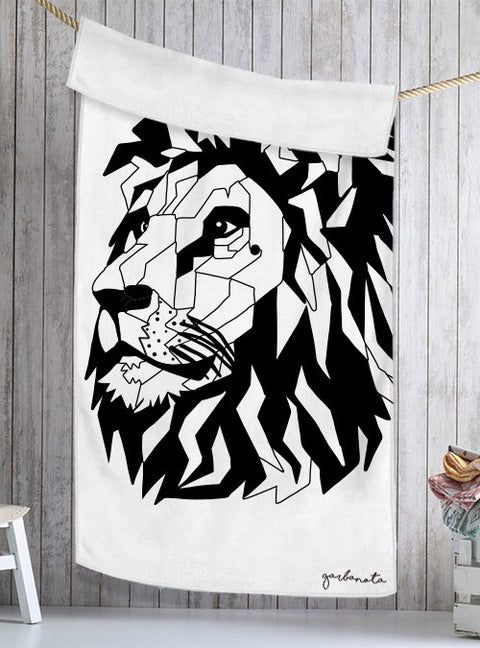 1. Garbanota Towel Black Lion in white, featuring a geometric lion design, hanging in a rustic setting