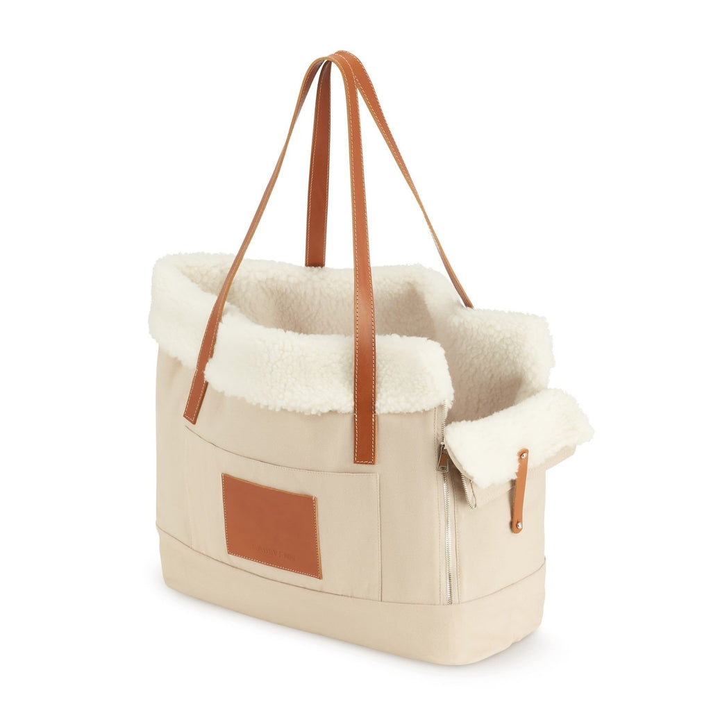 2. Beige Liiva dog carrier and personal bag with brown leather accents and soft wool insert shown in studio setting