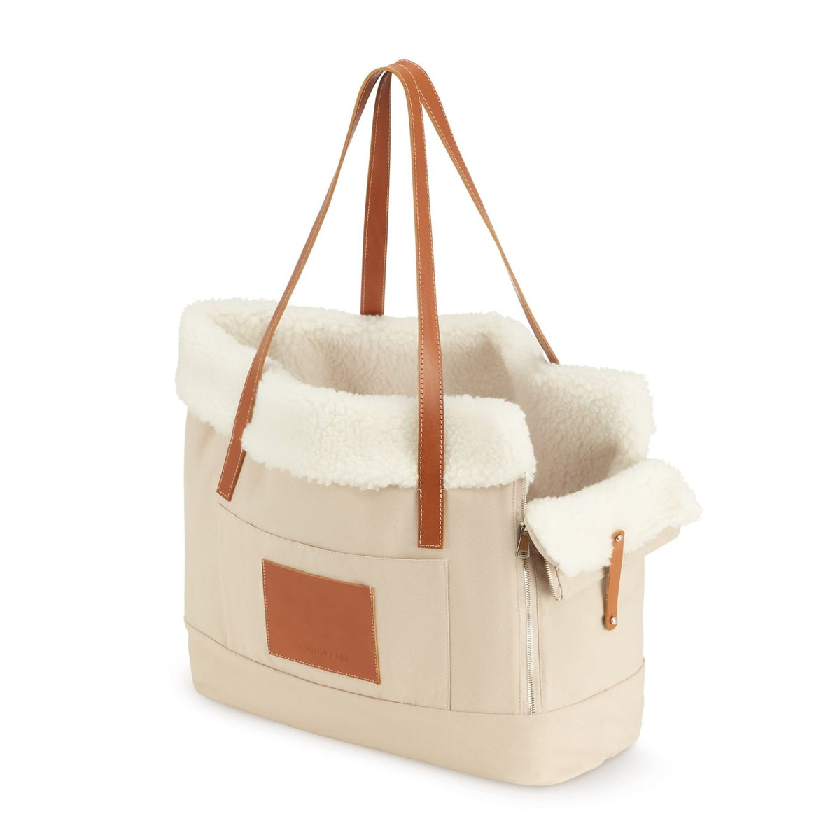 2. Beige Liiva dog carrier and personal bag with brown leather accents and soft wool insert shown in studio setting