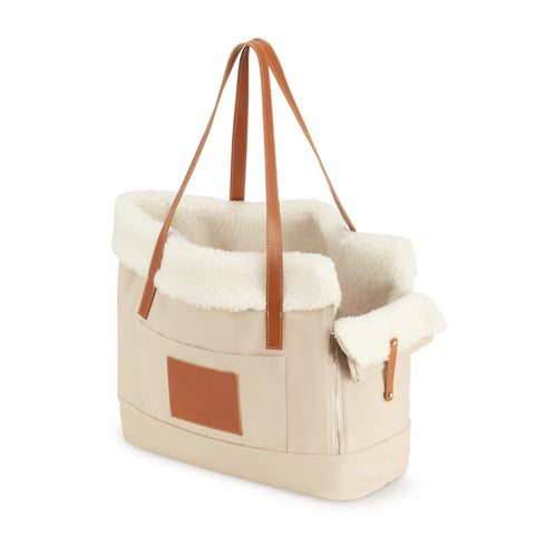 2. Beige Liiva dog carrier and personal bag with brown leather accents and soft wool insert shown in studio setting