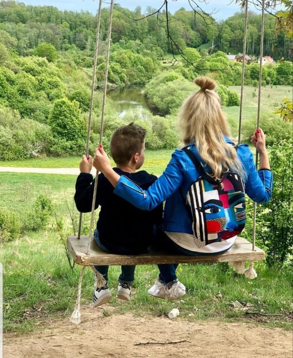 3. Woman on a swing with child, wearing Garbanota BACKPACK LOLITA with unique artwork