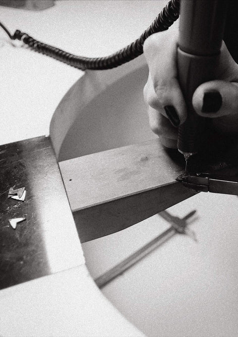 4. Close-up of the crafting process for NO MORE Love Necklace in silver, showing precision work