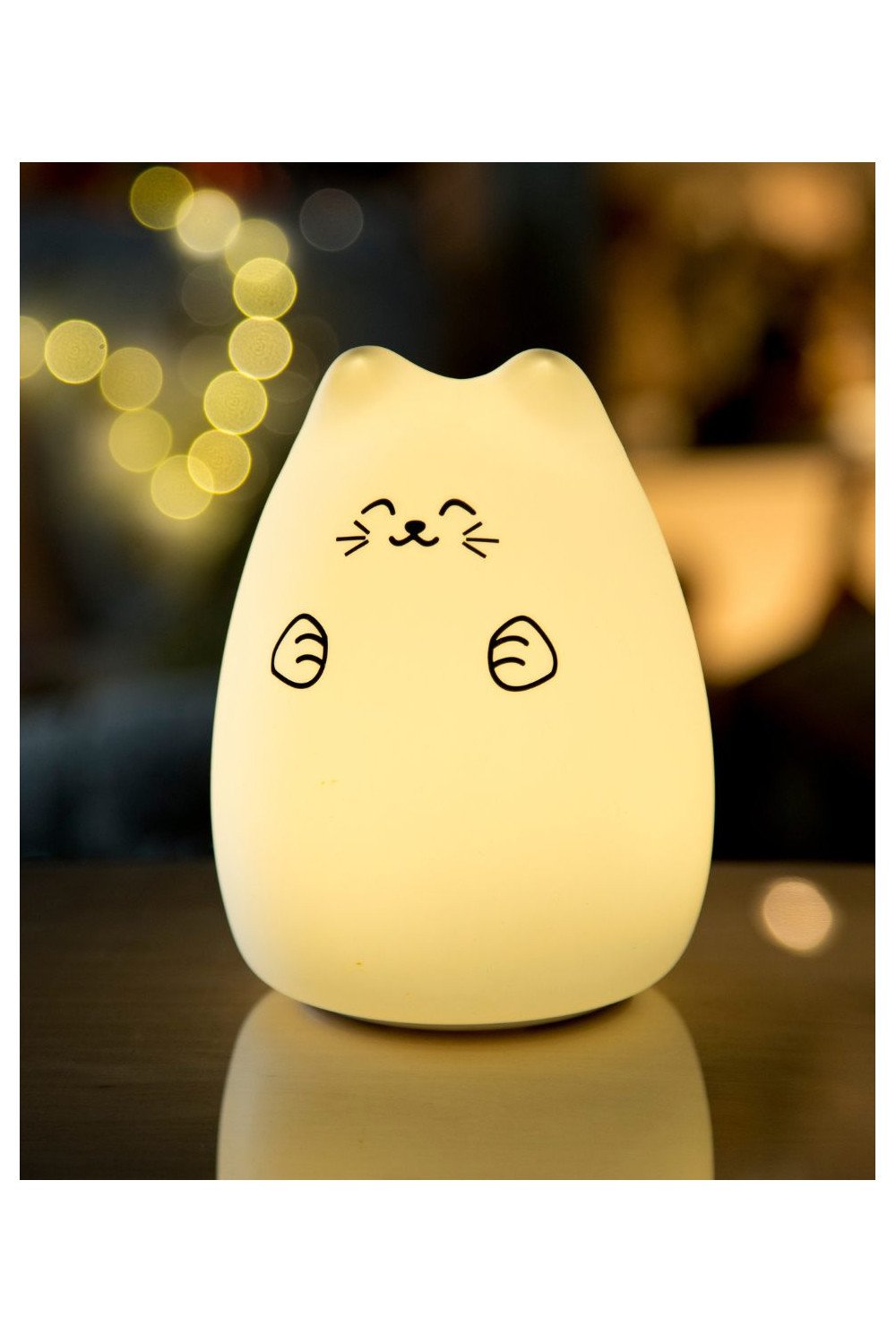 4. Warm glowing Lucky Cat silicone lamp on table with bokeh lights in background