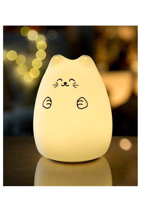 4. Warm glowing Lucky Cat silicone lamp on table with bokeh lights in background