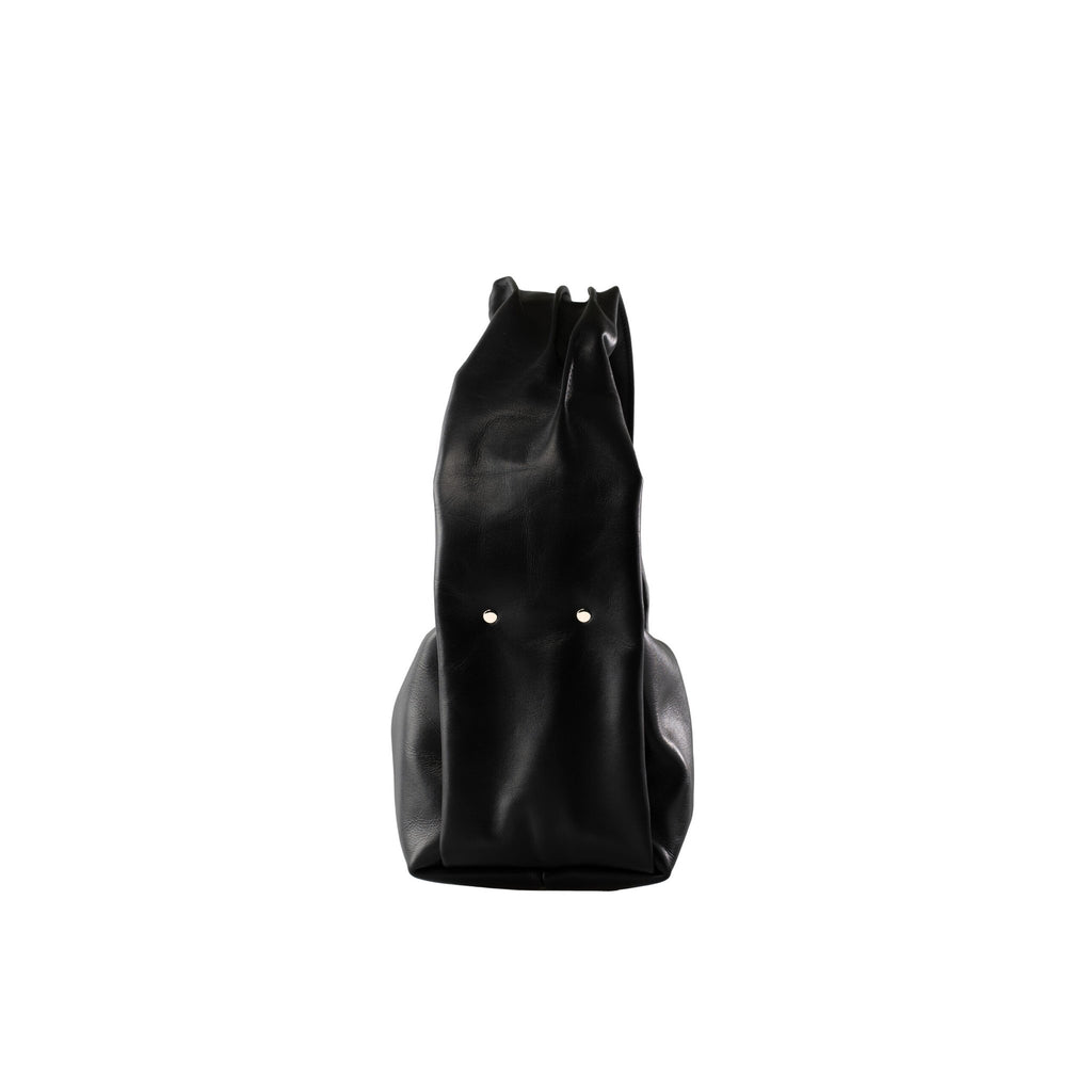 6. Side view of PYKOK Soft Leather Baguette Handbag Luna in black, highlighting natural leather texture