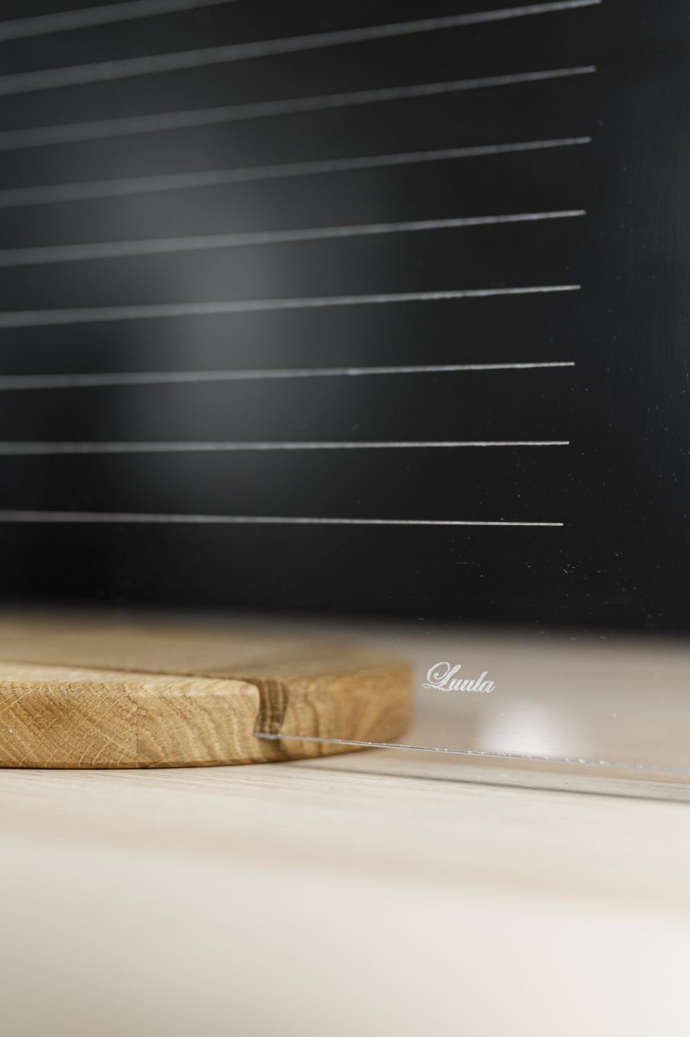 8. Detail of Luula acrylic planner with brand logo and wooden stand