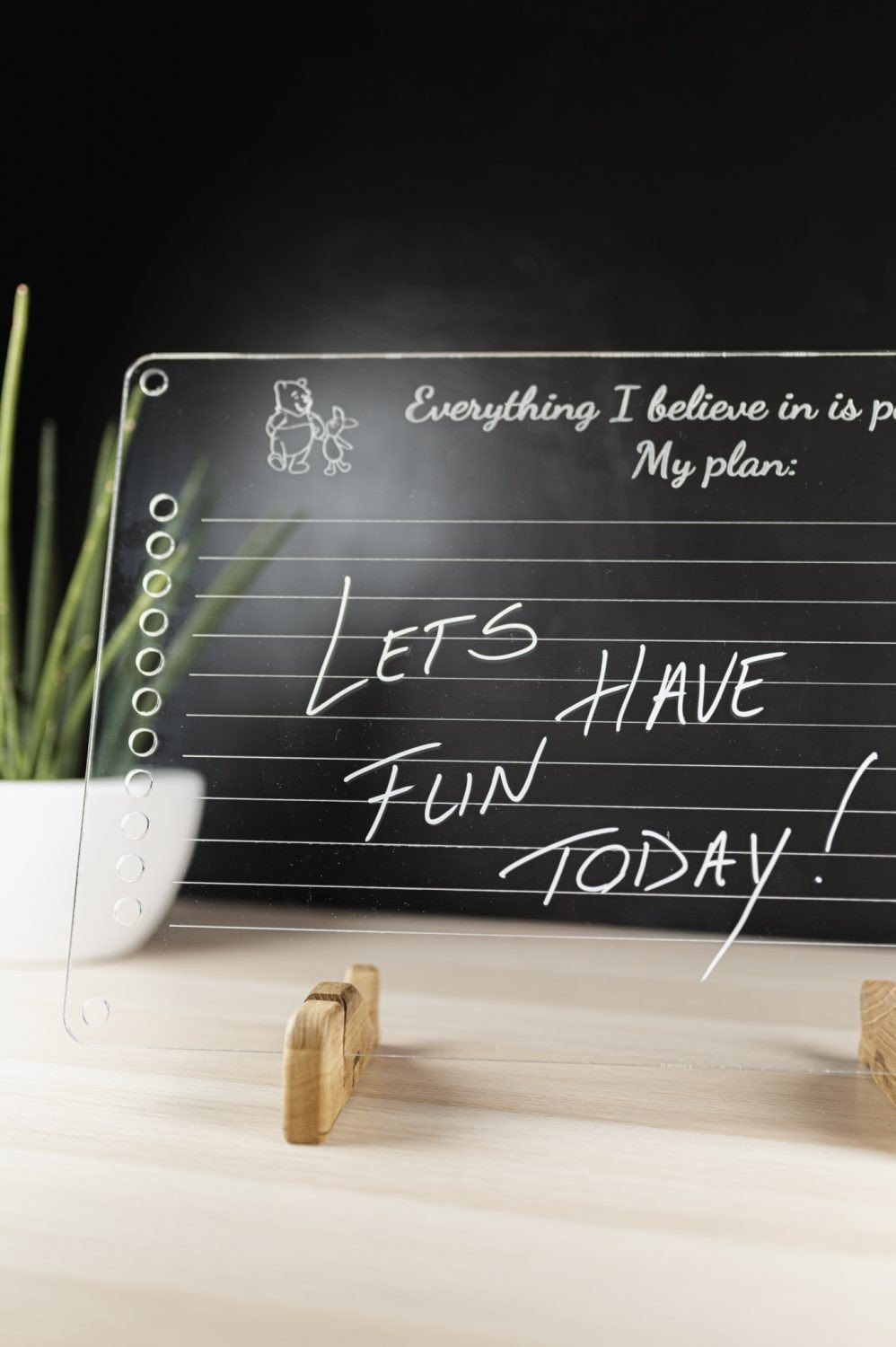 3. Luula acrylic planner with motivational text and handwritten message on wooden stand