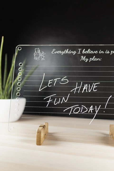 3. Luula acrylic planner with motivational text and handwritten message on wooden stand