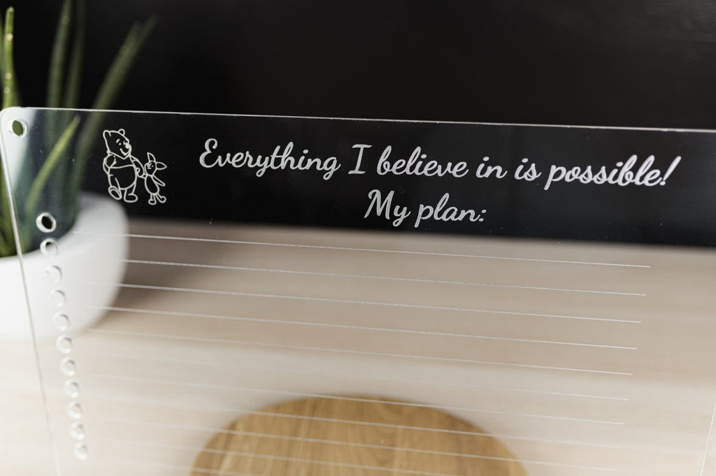 6. Close-up of Luula acrylic planner with motivational text on wooden stand