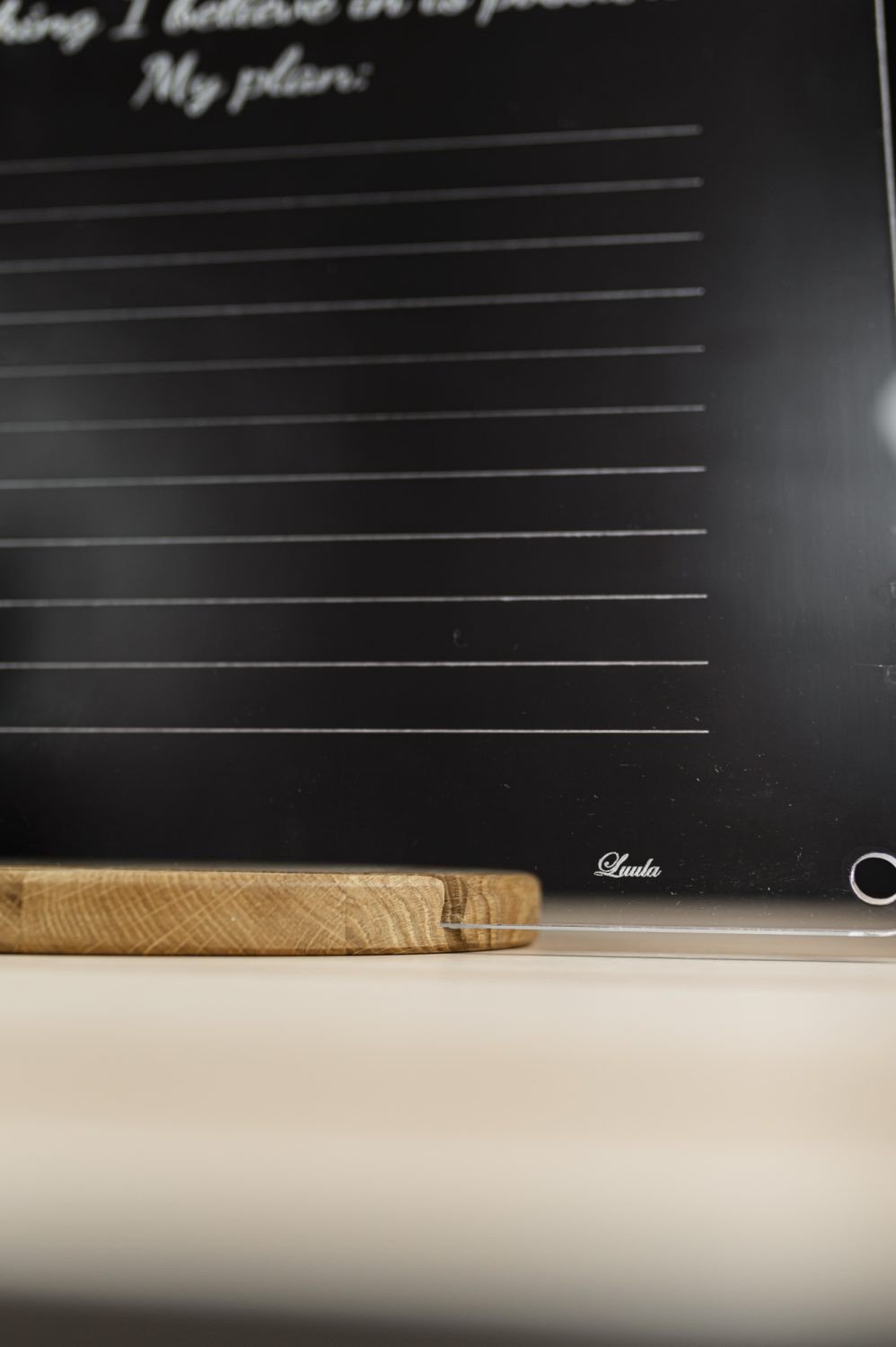 7. Close-up of Luula acrylic planner showing brand logo and wooden stand
