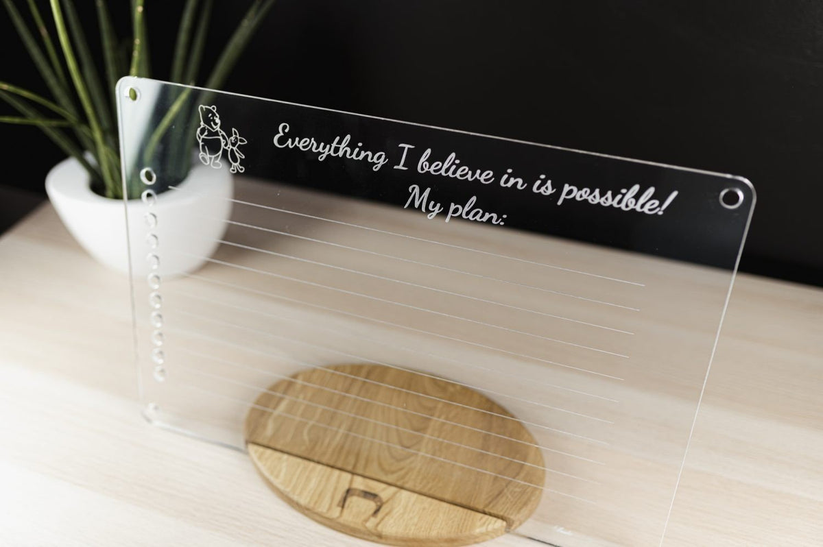 4. Angled view of Luula acrylic planner on wooden stand with motivational text