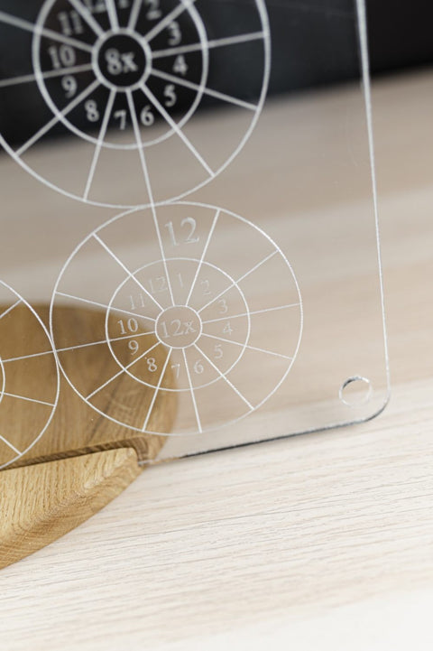 3. Detailed view of LUULA multiplication board's 12x table on clear acrylic with wooden stand