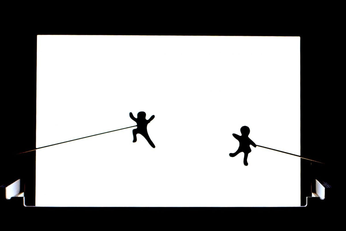 3. Silhouette figures on Luula light board creating shadow play effect