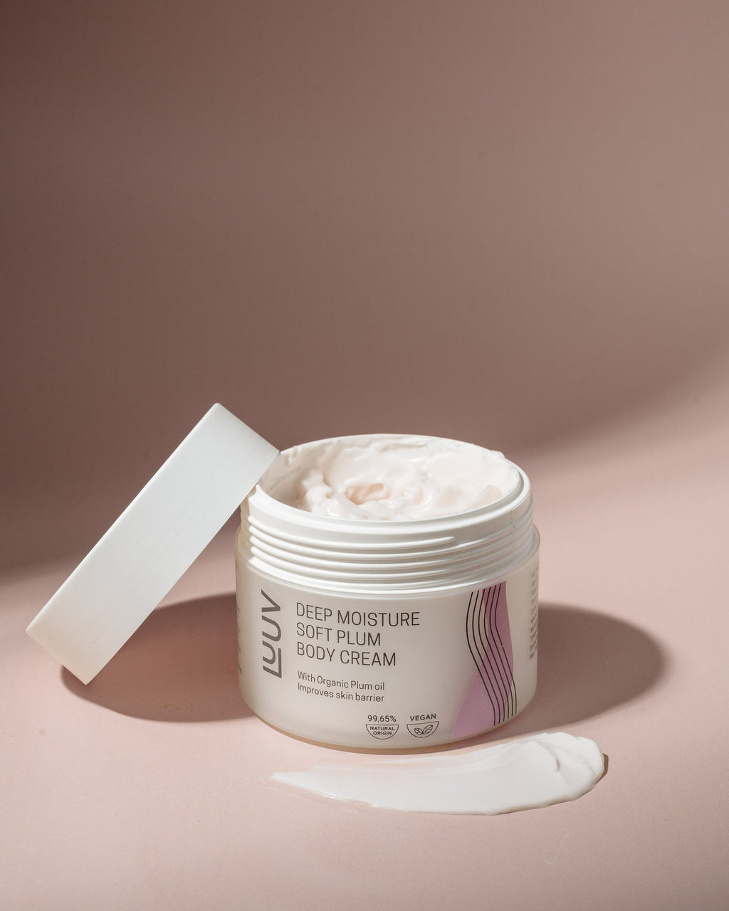 2. LUUV Deep Moisture Soft Plum Body Cream with lid open, showcasing creamy texture on a soft pink background