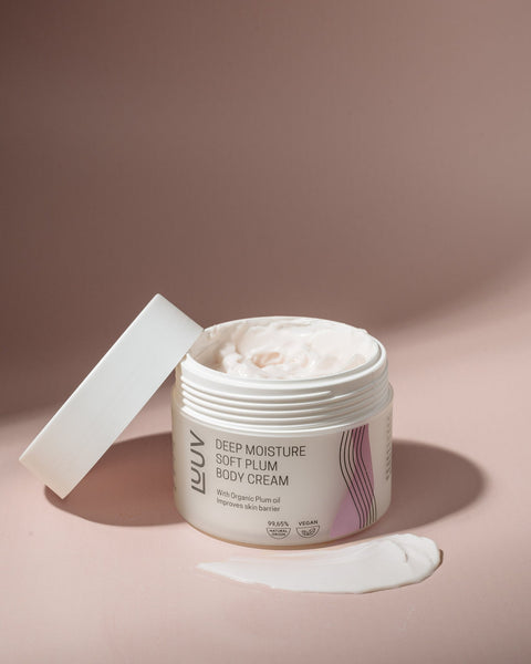 2. LUUV Deep Moisture Soft Plum Body Cream with lid open, showcasing creamy texture on a soft pink background
