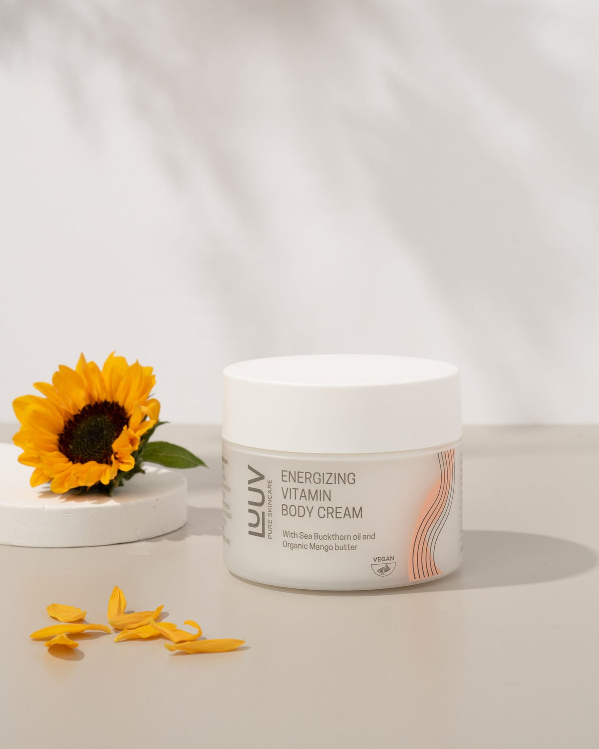 1. LUUV Energizing Vitamin Body Cream with Sea Buckthorn and Mango Butter, styled with sunflower in lifestyle setting