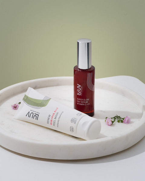 4. LUUV Super Glow Day Serum Vitamin C + D on marble tray with Renew Peel Mask, styled with flowers