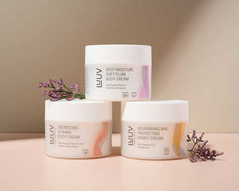 1. LUUV body cream collection featuring Deep Moisture Soft Plum, Energizing Vitamin, and Nourishing Honey creams with floral accents