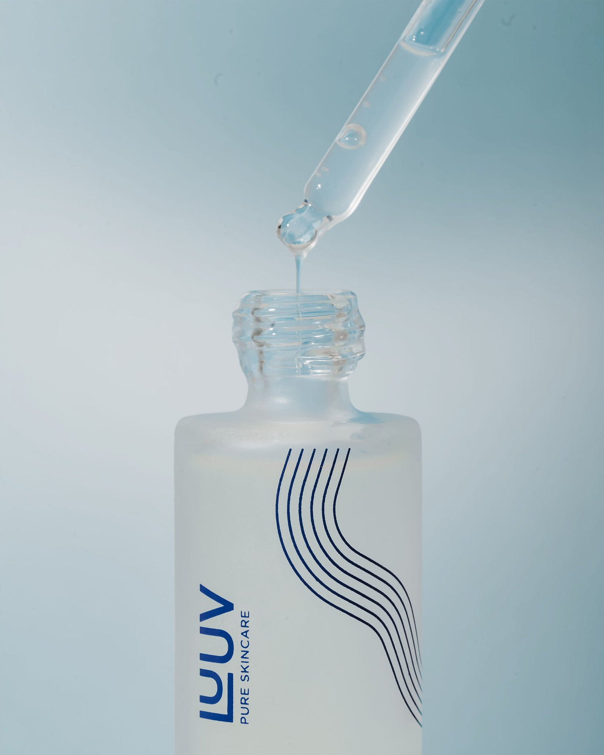 2. Close-up of LUUV BioLift Exosome-Hyaluronic Serum dropper dispensing serum into the bottle