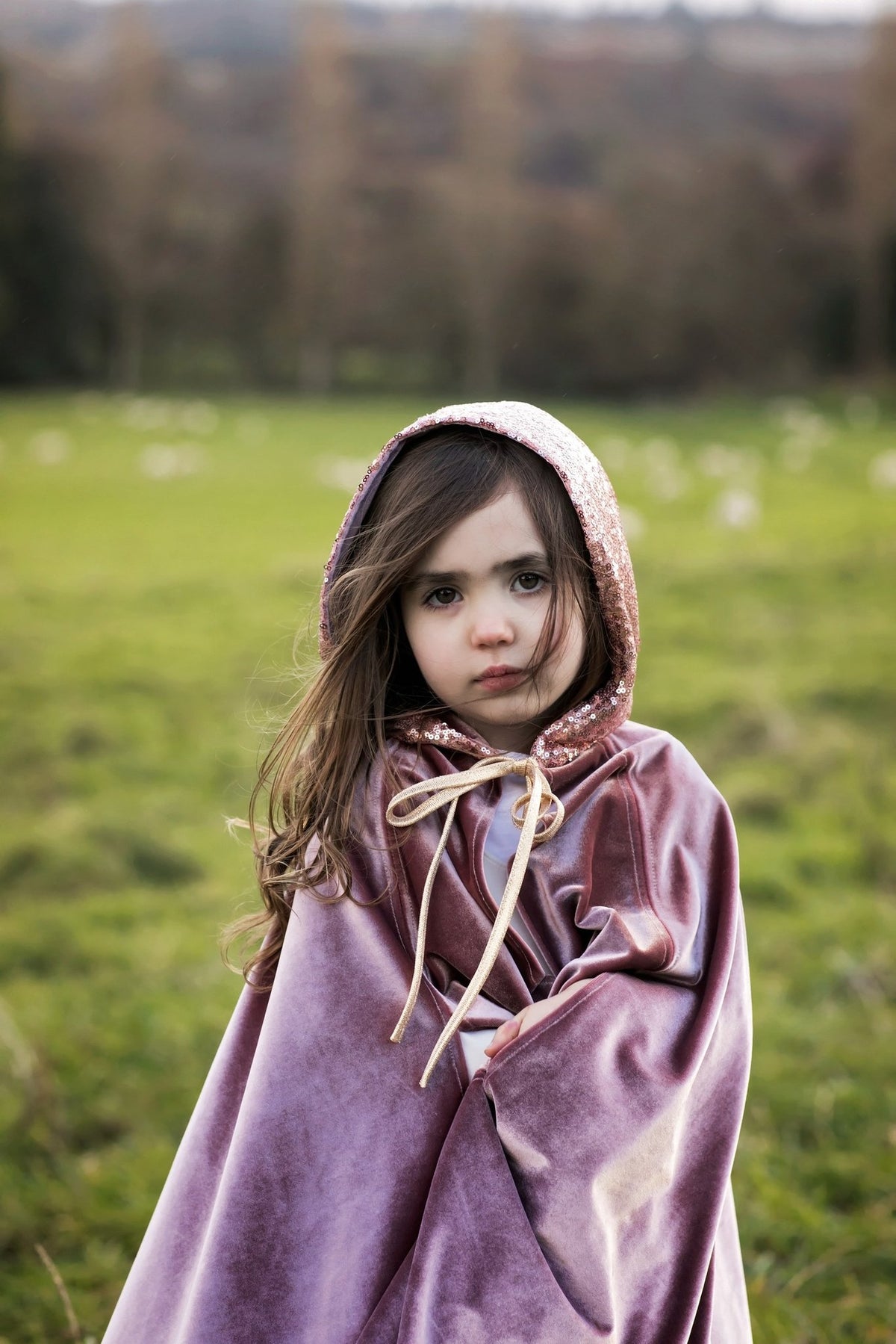 1. Girl in cosmic pearl cape with hood in a field, emphasizing the velour texture and storybook style